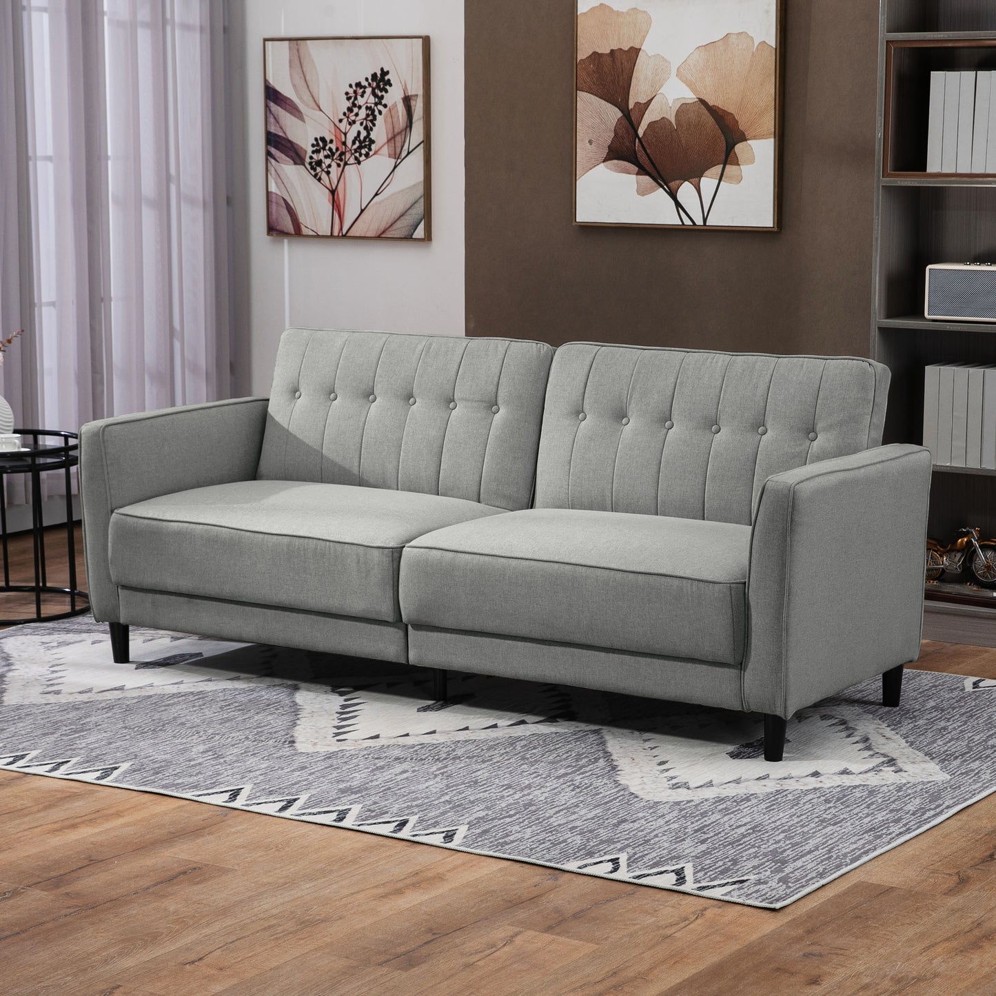 Canapé-lit convertible en tissu gris capitonné avec dossier ajustable, mobilier pratique et élégant pour salon ou chambre d’amis.