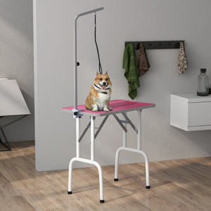 Folding grooming table with adjustable arm and non-slip surface, pink