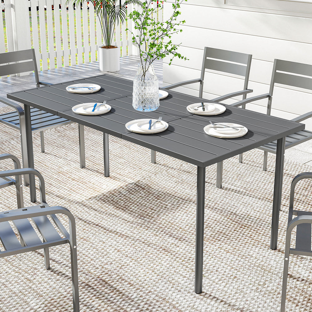 Outdoor dining table for 6 people, made of metal with a slatted top.