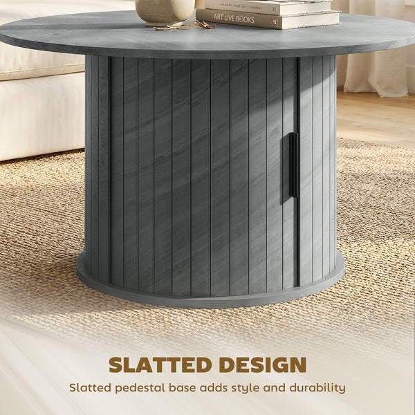 Table basse ronde avec base cannelée et rangement caché à porte coulissante – Gris ciment