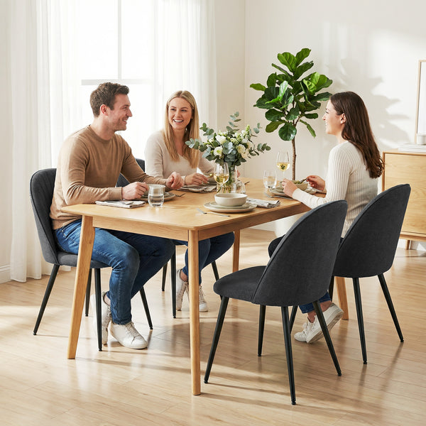Set of 4 modern dining chairs with metal legs, shell back, and upholstered seat, black.