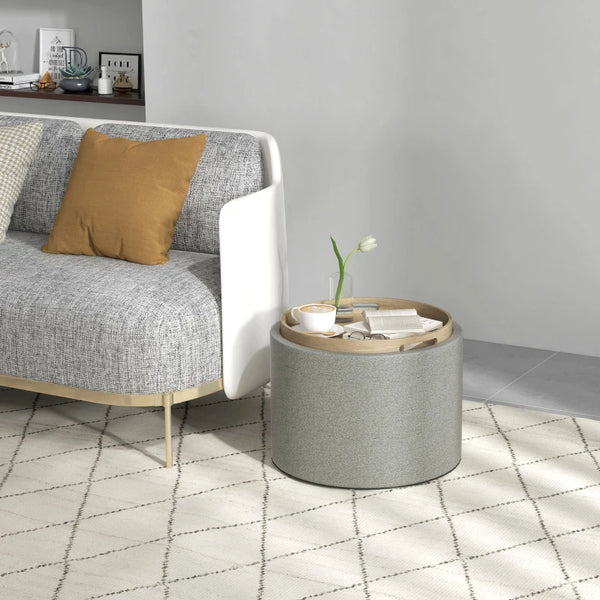 Table basse ronde avec rangement dissimulé et plateau rembourré en lin gris