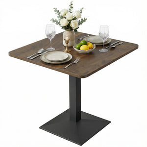 Table de salle à manger carrée avec piètement en acier, compacte et peu encombrante, aspect noyer.