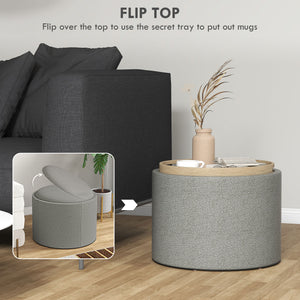 Table basse ronde avec rangement dissimulé et plateau rembourré en lin gris