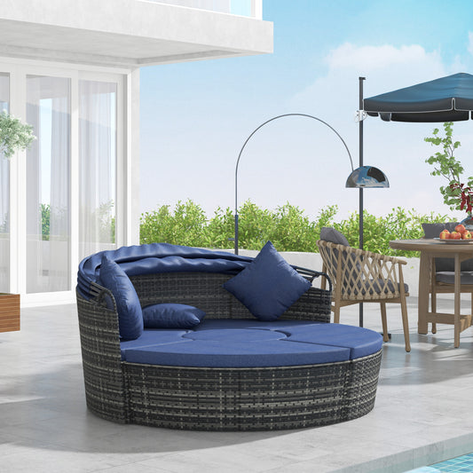 Méridienne d’extérieur 4 pièces avec coussins bleu foncé et auvent rétractable, idéale pour se détendre au soleil ou à l’ombre sur une terrasse ou près de la piscine