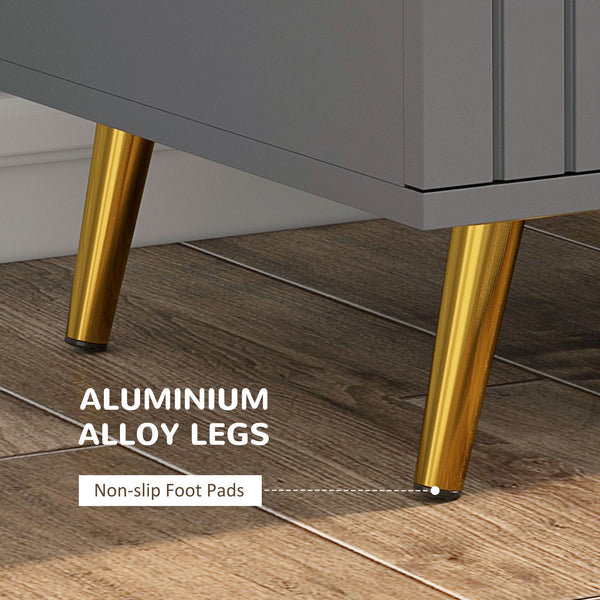 Commode à 3 tiroirs avec pieds en aluminium et poignées dorées, gris foncé.