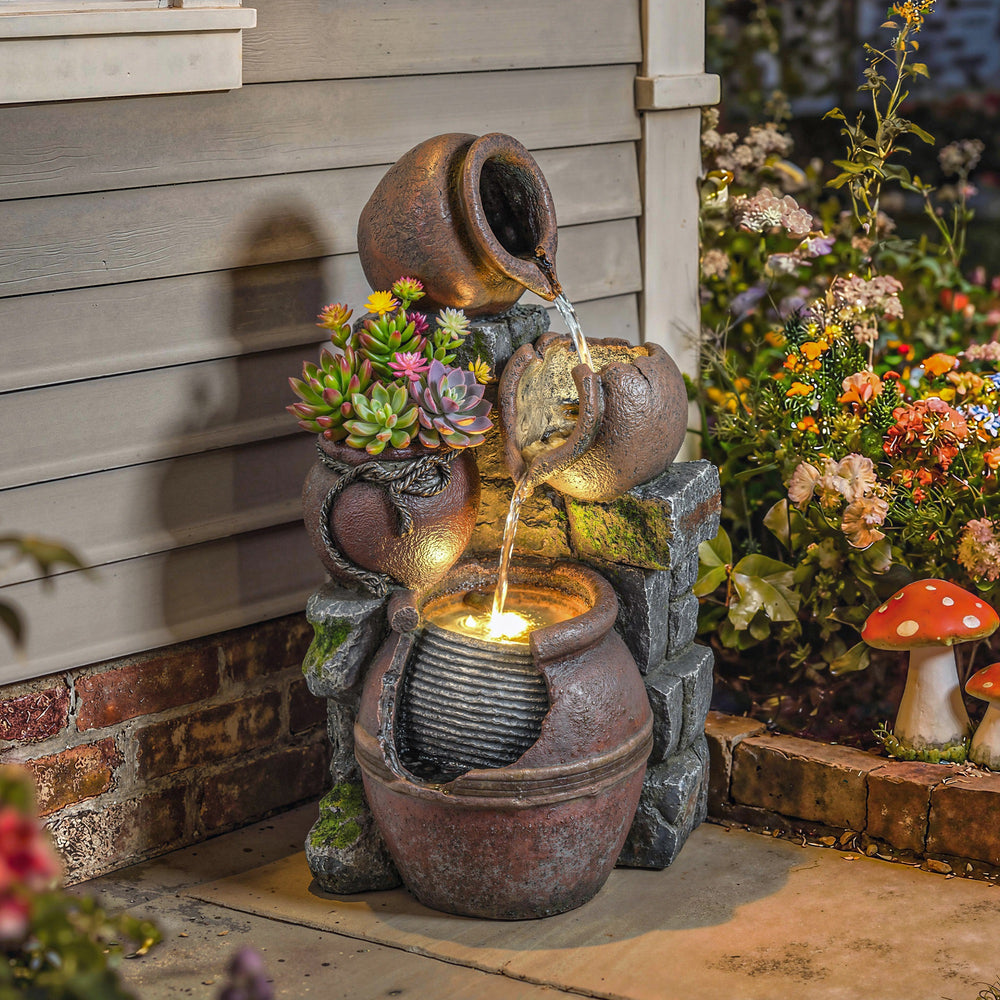 Fontaine d'extérieur avec pot rustique à 4 niveaux, éclairage LED et débit réglable.