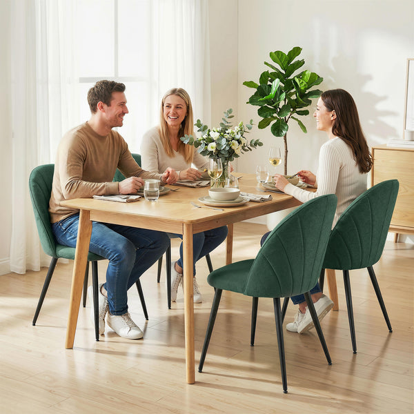 Set of 4 modern dining chairs with metal legs, shell back, and upholstered seat, green.